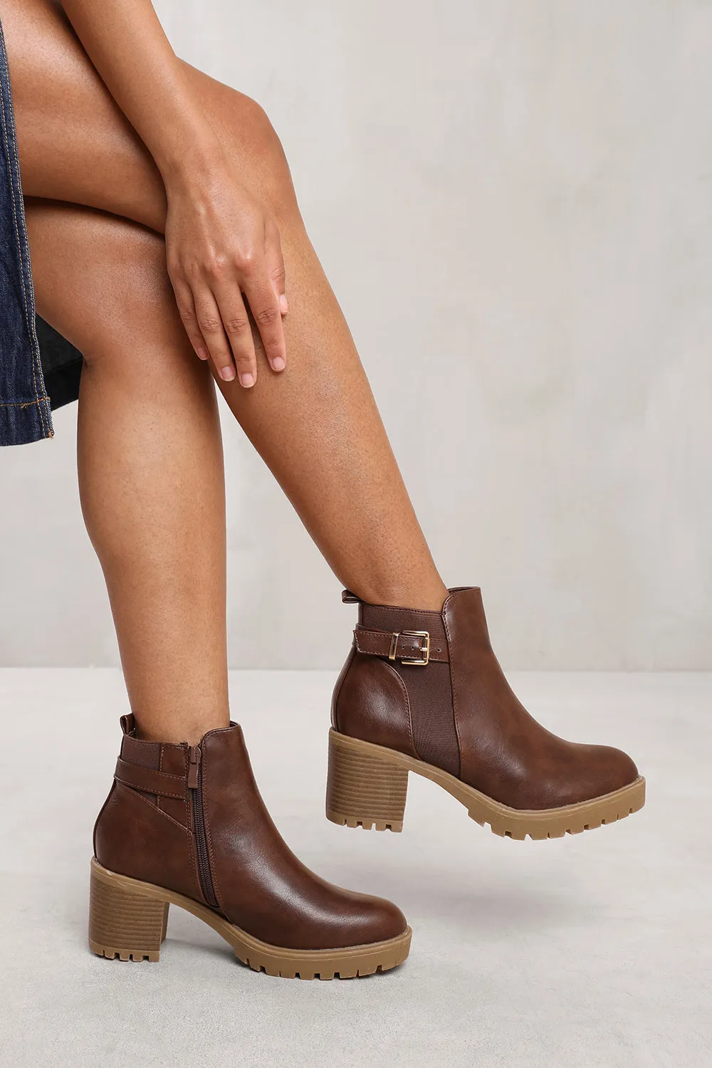 ARLETH MID BLOCK HEEL WITH BUCKLE DETAIL STRETCH ANKLE BOOTS IN BROWN